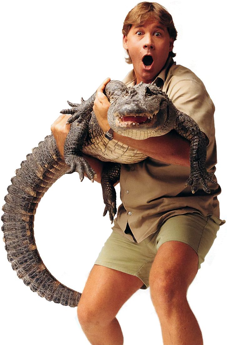 a man holding an alligator in his arms and making a surprised face with his mouth wide open