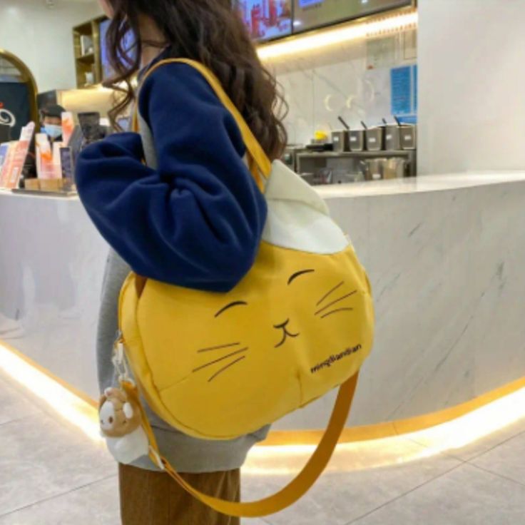 Cute Cat Face Shoulder Bag, Kawaii Cartoon Crossbody Bag, Large Capacity Round Bag Trendy Large Capacity Yellow Satchel, Trendy Yellow Satchel With Large Capacity, Casual Yellow Canvas School Bag, Kawaii Shoulder Bag With Cat Design For Daily Use, Kawaii Cat Design Shoulder Bag For Daily Use, Cute Yellow Bag With Adjustable Strap, Cute Yellow Bags With Adjustable Strap, Cute Yellow Satchel Bag, Yellow Harajuku Bag For Daily Use