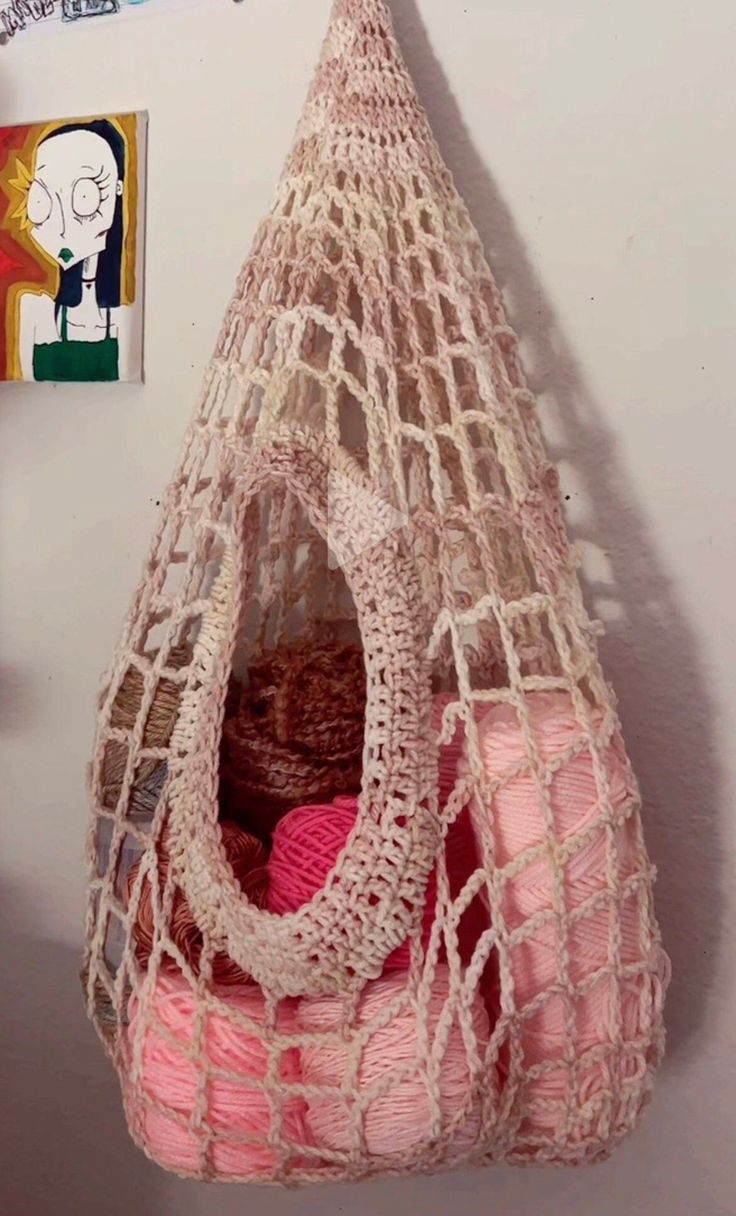 a pink bag hanging from the wall