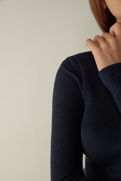 Long-sleeve high-neck tubular top made from a wool-silk blend. Fitted Ribbed Merino Wool Top, Elegant Ribbed Merino Wool Tops, Elegant Long Sleeve Turtleneck With Ribbed Neckline, Blue Fine Knit Merino Wool Top, Fine Knit Merino Wool Blue Top, Long Sleeve Ribbed Merino Wool Top, Ribbed Merino Wool Long Sleeve Tops, Fine Knit High Neck Merino Wool Top, Stretch Merino Wool Turtleneck Top