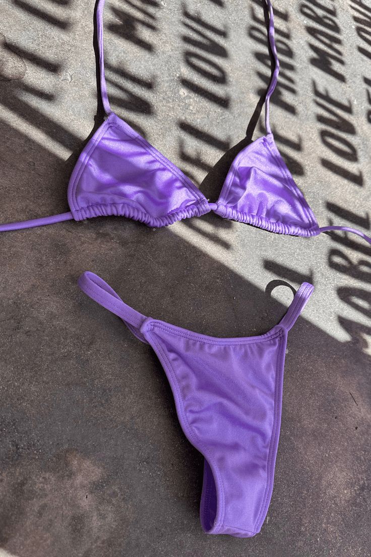 Introducing our stunning Unicorn lavendar 2 Piece T String Bikini! This eye-catching swimsuit is beautifull in the sunlight. The bikini top features a flattering halter neckline and adjustable straps for a comfortable and secure fit. The matching bottom offers moderate coverage with a scrunch bottom. Perfect for the fashion-forward beach-goer, this Unicorn 2 Piece Bikini is sure to turn heads and make a statement. Get ready to shine this summer with this must-have swimsuit! This Unicorn Lavender Purple Halter Neck Swimwear For Beach, Poolside Purple Halter Neck Swimwear, Purple Halter Neck Swimwear For Summer, Summer Halter Neck Purple Swimwear, Purple Halter Neck Swimwear For Beach Party, Purple Halter Neck Swimwear For Pool, Purple Triangle Top Swimwear For Poolside, Summer Lavender Swimwear For Swimming, Purple Triangle Top Swimwear With Adjustable Straps