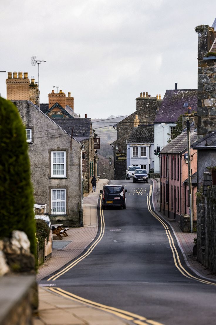 an empty street with cars parked on both sides