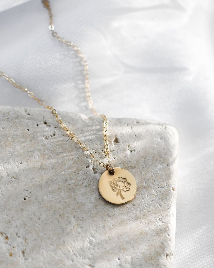 · 1/2" (12.7mm) disc· 14k yellow gold fill, 14k rose gold fill, and sterling silver options· Sturdy, timeless, and built to be worn everydayOur classic 1/2” necklaces are easy to layer, elegant, and ready to be personalized with your most special sentiments, moments, and memories! Created to last a lifetime, these necklaces will remain evergreen even as the years and trends come and go.Personalizing your piece with a message? Reference our fonts and symbols chart for font options and character m Dainty 14k Gold Filled Engraved Charm Necklaces, Engraved Flower Pendant Jewelry For Everyday, Everyday Engraved Flower Pendant Jewelry, Everyday Birth Flower Pendant Jewelry, Hypoallergenic 14k Gold Filled Round Pendant Jewelry, Hypoallergenic 14k Gold-filled Round Pendant Jewelry, Hypoallergenic 14k Gold Filled Round Pendant, Everyday Hypoallergenic 14k Gold-filled Charm Necklaces, Everyday Hypoallergenic Yellow Gold Necklace