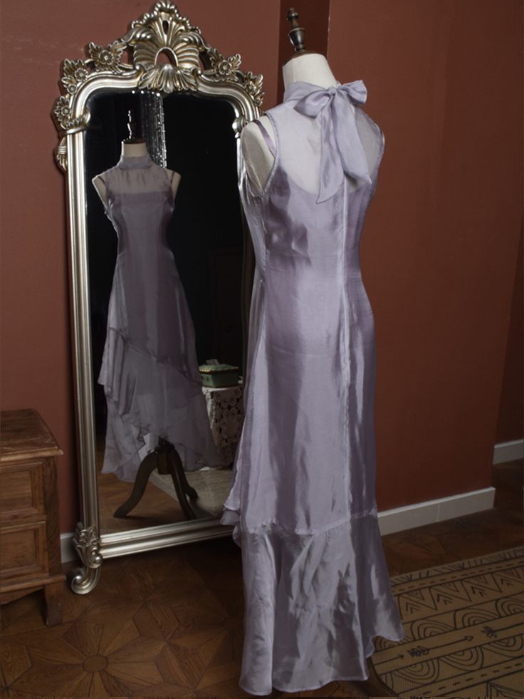 Elevate your wardrobe with this exquisite two-piece set, combining timeless elegance with contemporary flair. The Light Purple Vintage Slip Dress exudes a nostalgic charm with its delicate hue and classic silhouette, featuring adjustable spaghetti straps for a perfect fit. The soft, flowing fabric gracefully drapes over your figure, creating an ethereal look that's perfect for both daytime outings and evening soirées.  Complementing the slip dress is a sophisticated High Neck Sleeveless Asymmetr Elegant Asymmetrical Dress For Daywear, Elegant Sleeveless Asymmetrical Dress With Fitted Bodice, Fitted Asymmetrical Dress For Daywear, Feminine Sleeveless Asymmetrical Dress For Evening, Elegant Asymmetrical Wedding Dress For Spring, Elegant Asymmetrical Spring Dress For Daywear, Elegant Asymmetrical Dress For Spring Daywear, Elegant Dresses With Bias Cut And Asymmetrical Hem, Classic Sleeveless Bias Cut Dress