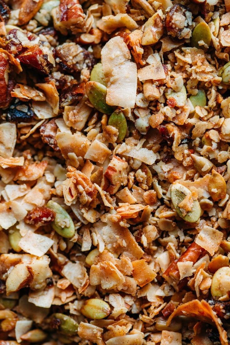 a mixture of granola, nuts, and dried fruit on top of each other