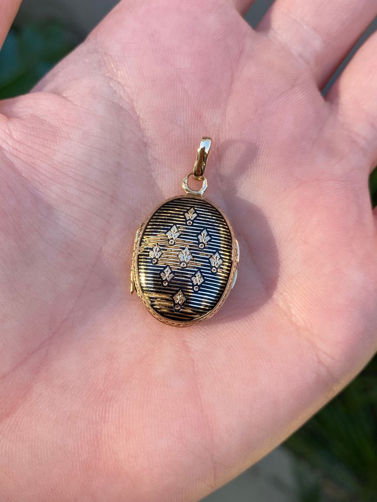 Total Weight: 4.9 grams Length: 3.1cm (including bail) Width: 1.9cm Condition: In good condition with some wear to the enamel. Locket doesn't lock shut but it doesn't swing open while it's on.  All gold has been thoroughly checked with an Olympus XRF spectrometer. It is guaranteed 18k gold.  All our jewelry is properly washed and disinfected to ensure customers get clean items with every order.  Returns accepted but may be subjected to a restock fee.  Please message with any questions:) Gold Jewelry With Black Enamel For Anniversary, Black 14k Stamped Jewelry As Gift, Luxury Engraved Enamel Jewelry, Black 14k Stamped Jewelry For Gift, Traditional Black Jewelry With Polished Finish, Formal Black Locket Jewelry, Traditional Black Hallmarked Jewelry, Collectible Black Jewelry With Round Pendant, Black Locket Jewelry For Anniversary