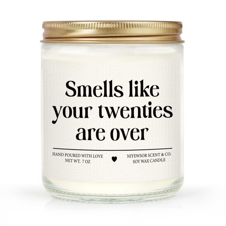 a candle that says smells like your twenties are over on the front and back of it