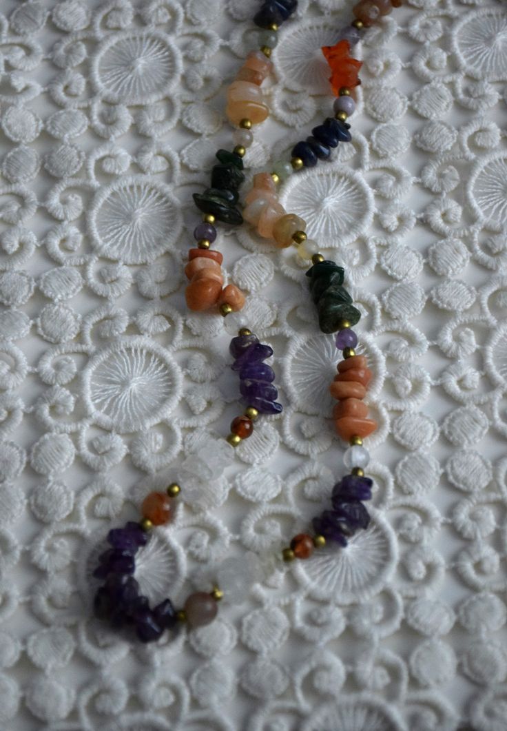 Vintage multicolored gemstone beaded necklace, featuring amethyst, carnelian, crystal quarts, onyx, agate. The necklace consists of one strand of stone chip beads, arranged by color with brass spacers between the different type of gemstones. Closes with screw barrel clasp at the back Era - 1980s Approx. Length (with clasp) - 24 inches / 61 cm Condition - Very good vintage condition, some dents on the stones! Adjustable Round Bead Mineral Crystal Necklaces, Adjustable Mineral Crystal Round Beads Necklace, Colorful Agate Beads Spiritual Jewelry, Spiritual Agate Jewelry With Colorful Beads, Amber Crystal Necklace With Natural Stones For Healing, Adjustable Gemstone Beaded Necklace With Mineral Crystal, Multicolor Crystal Necklaces With Natural Stones For Gift, Multicolor Mineral Crystal Necklaces For Jewelry Making, Multicolor Gemstone Crystal Necklaces