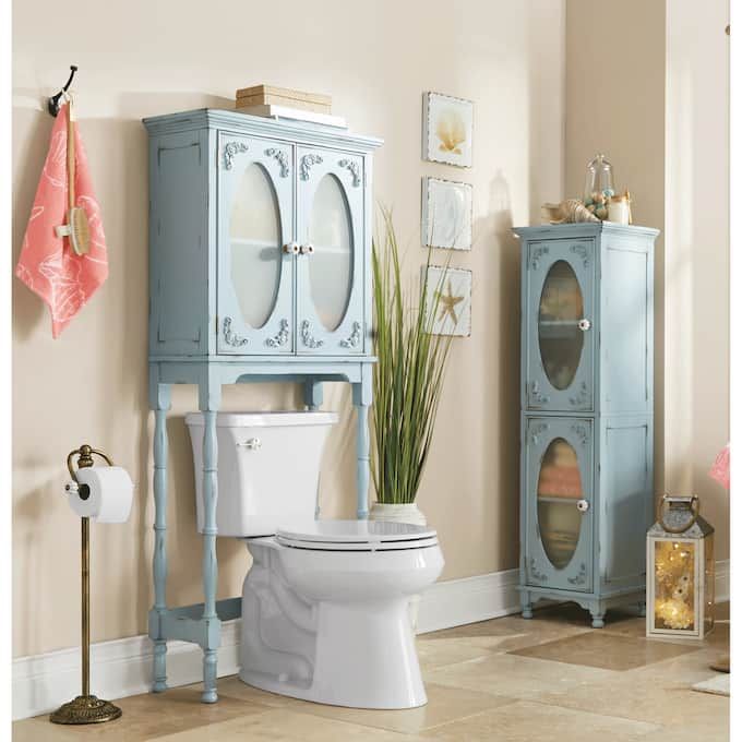 a white toilet sitting next to a tall blue cabinet in a room with beige walls