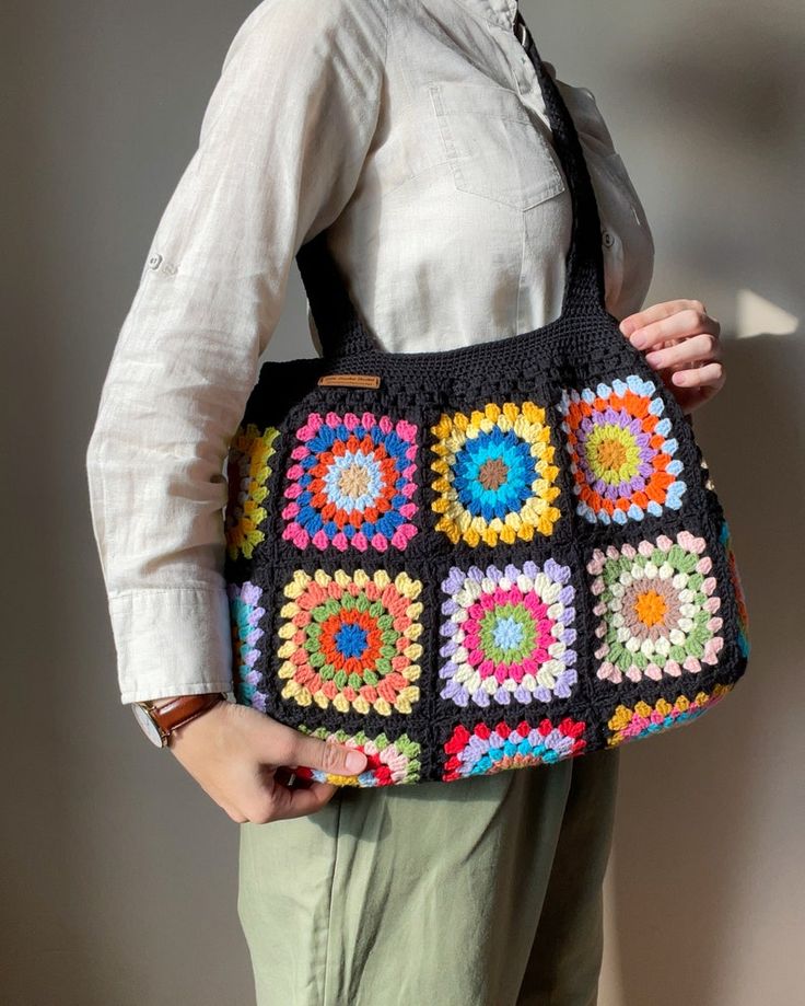 Crochet Black Shoulder Bag Colorful Floral Granny Square Tote - Etsy Black Crochet Square Bag, Black Square Crochet Bag, Black Square Crochet Bag Bohemian Style, Handmade Black Crochet Bag With Double Handle, Retro Granny Square Shoulder Bag, Retro Granny Square Shoulder Bag For Everyday Use, Black Bohemian Crochet Square Bag, Black Square Bohemian Crochet Bag, Colorful Square Shoulder Bag For Everyday