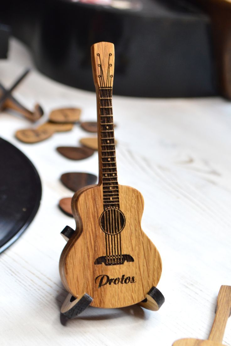 a wooden guitar sitting on top of a table