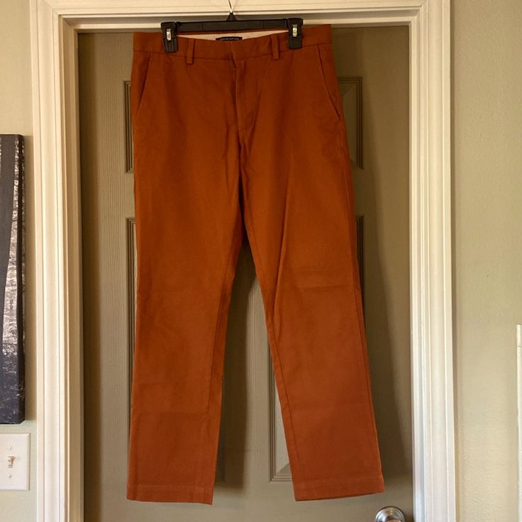 Rust Orange Chino Pants With Double Button/ Slide Closure. Heavyweight 100% Organic Cotton. Never Worn Brown Straight Leg Dress Pants With Pockets, Casual Brown Cotton Dress Pants, Brown Flat Front Cotton Pants, Brown Cotton Flat Front Pants, Casual Brown Dress Pants With Pockets, Brown Flat Front Cotton Bottoms, Brown Cotton Flat Front Bottoms, Brown Flat Front Pants With Pockets, Casual Brown Flat Front Bottoms