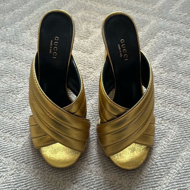 Gucci Gold Webby Cross Over Sandals. Please Note Condition In Photos. Size 37. Heel Is 4.25. Designer Gold Sandals With Wrapped Heel, Designer Gold Sandals With Heel Loop, Gucci Block Heel Evening Sandals, Gucci Evening Sandals With Block Heel, Gucci Block Heel Sandals For Evening, Gucci Formal Block Heel Sandals, Luxury Gold Mules With Block Heel, Gucci Evening Sandals With Round Toe, Gucci Gold Sandals For Formal Occasions