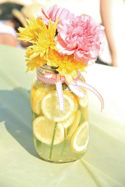 a mason jar filled with lemon slices and flowers