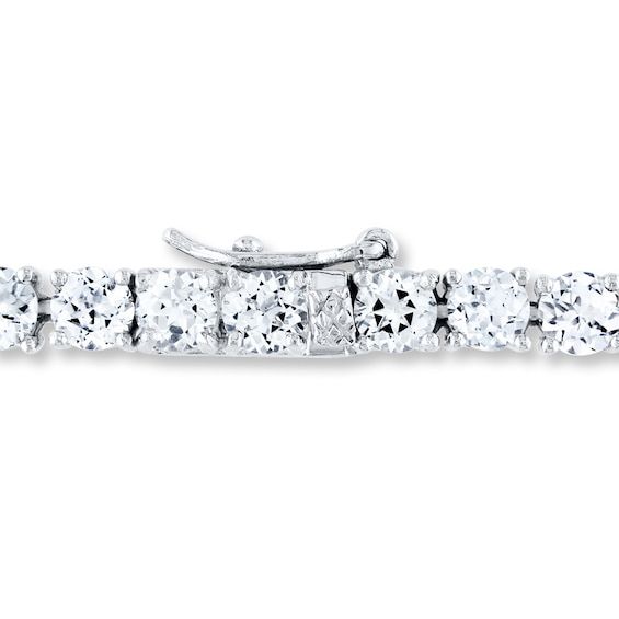 This elegant bracelet for her features a row of shimmering round lab-created white sapphires. Fashioned in sterling silver, the 7.25-inch bracelet is secured with a tongue clasp. Classic Sterling Silver Bracelet With Sparkling Stones, Classic Sterling Silver Tennis Bracelet With Sparkling Stones, White Sterling Silver Tennis Bracelet For Anniversary, Classic White Sterling Silver Bracelet With Diamond Accents, Dazzling White Sterling Silver Tennis Bracelet, Fine Jewelry White Bracelets With Sparkling Stones, White Bracelets With Sparkling Stones In Fine Jewelry Style, White Bracelets With Sparkling Stones Fine Jewelry, White Diamond Bracelet With Sparkling Stones In Sterling Silver