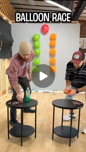 two men are playing with balloons on tables