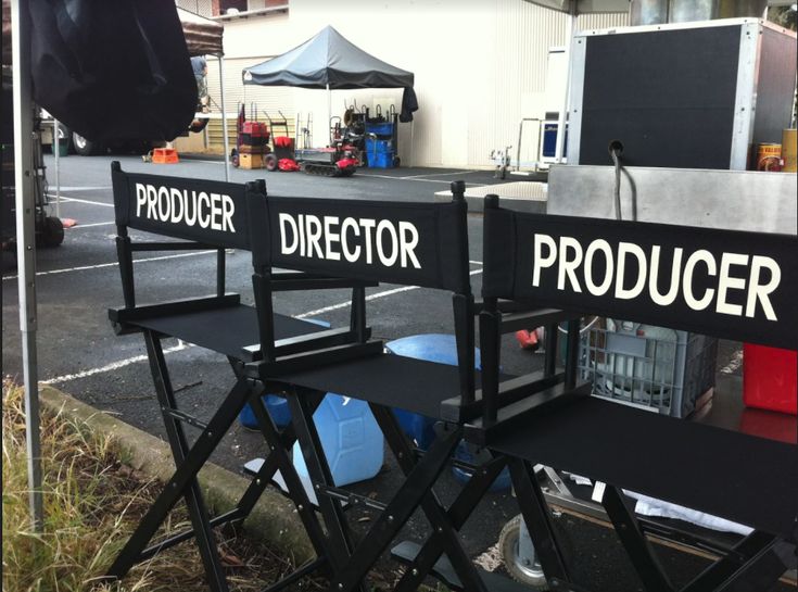 two director chairs sitting next to each other in front of a sign that says product