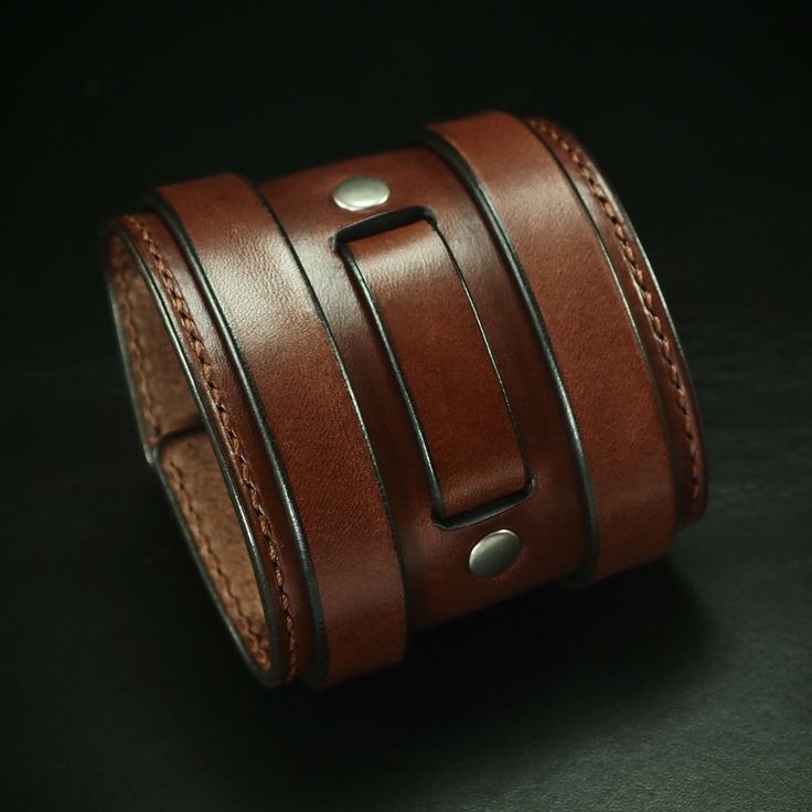 This leather cuff uses top grain, Italian, vegetable tanned bridle leather and is hand stitched along the edges.   It has 2 straps woven through the leather and a small center strap attached with hand set rivets. 2 antique nickel roller buckles provide the closure.  Antique brass hardware available! Just ask! I need your wrist size for this special cuff! Please use the Instructions in the pics above!  - 3" wide tapered band - brown bridle leather - Vegetable tanned  Thx! Freddie ✻ Please leave a Adjustable Leather Wristband With Waxed Finish, Classic Adjustable Leather Wristband, Adjustable Classic Leather Wristband, Adjustable Waxed Leather Bracelet, Adjustable Rugged Leather Bracelet, Leather Double Band Bracelet With Leather Strap, Adjustable Leather Cuff Bracelet With Waxed Finish, Adjustable Distressed Brown Leather Bracelet, Classic Double Band Leather Bracelets