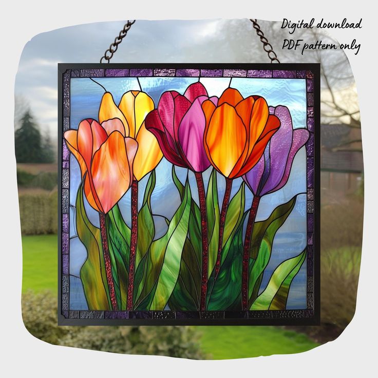 a colorful stained glass window with flowers in the center and chain hanging from it's frame