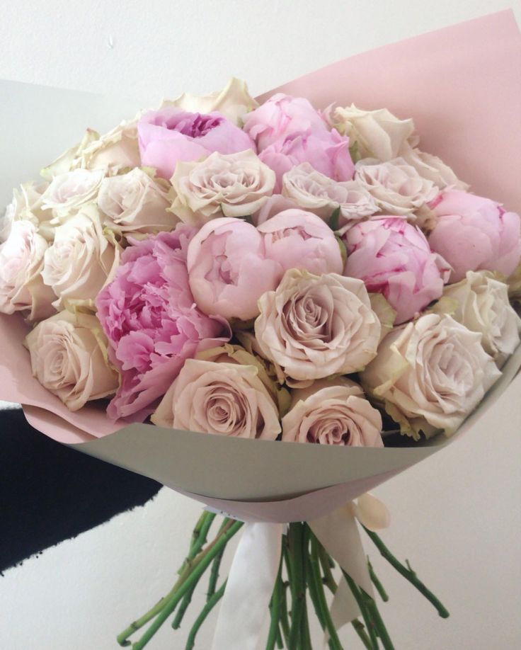 a bouquet of pink and white flowers in a vase