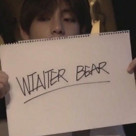 a person holding up a sign that says water bear