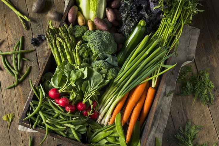 a wooden box filled with lots of different types of vegetables