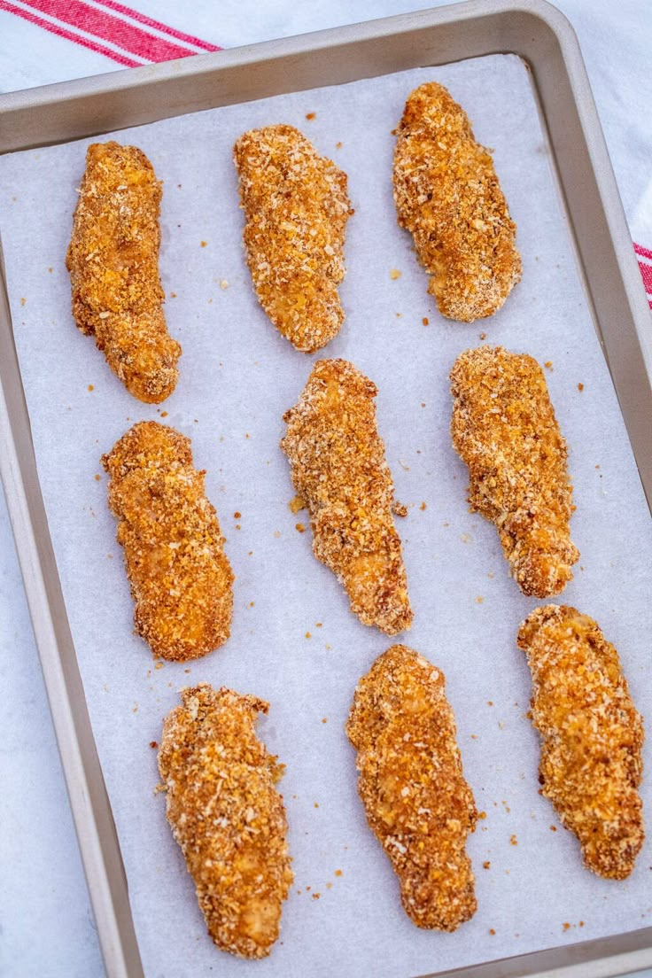 chicken tenderies on a baking sheet ready to go into the oven