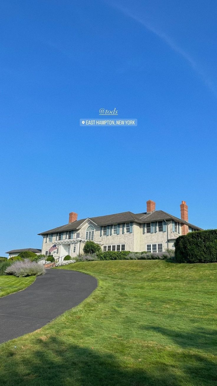 a large house sitting on top of a lush green field