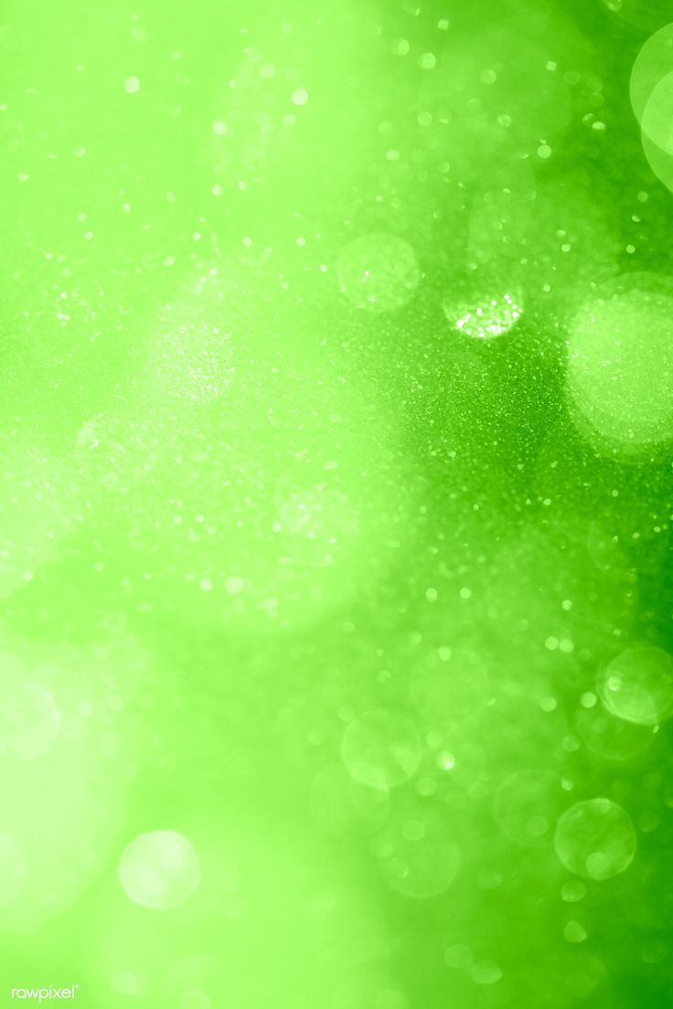 green blurry background with lots of water droplets on it's surface and the light is shining brightly