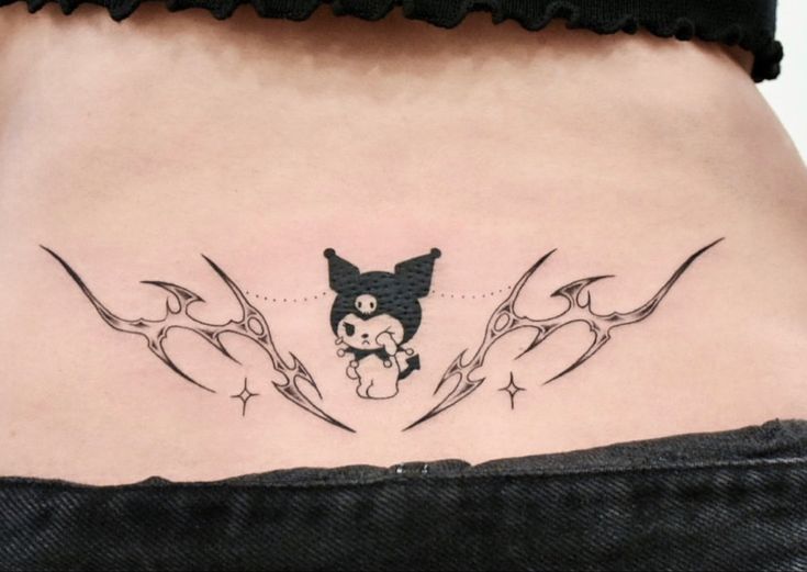 a woman's lower back tattoo with an image of a dog and stars on it