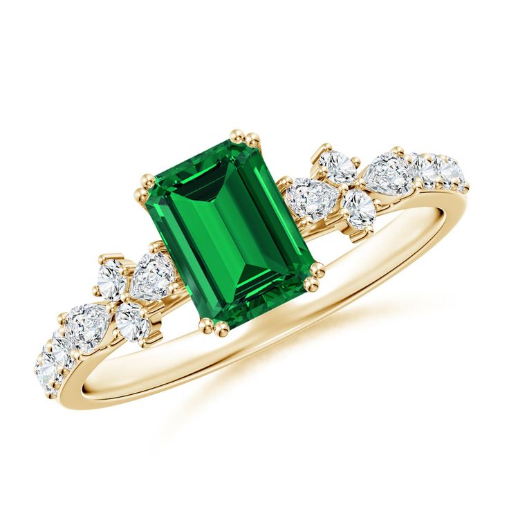 an emerald and diamond ring on a white background