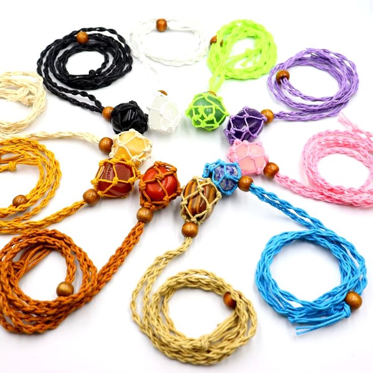 many different colored cords and beads on a white surface