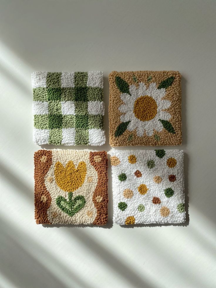 four squares with flowers and leaves on them are arranged in the shape of small squares