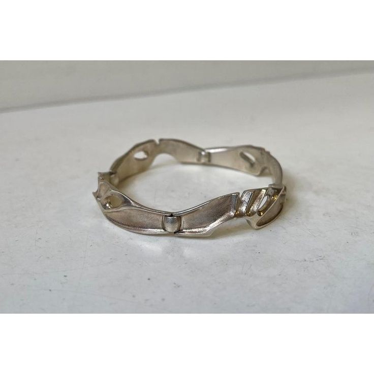 Much sought after vintage 'organic' modern sterling silver bracelet. Fully hallmarked by Lapponia, Finland. Designed during the 1970s by Bjorn Weckstrom.  Measures: Length closed: 7.1in / 18cm. Width: 14mm. Weight: approx. 25 grams. This piece has an attribution mark,   I am sure that it is completely authentic and  take full responsibility for any authenticity   issues arising from misattribution Metal Bracelets With Polished Finish For Anniversary, Metal Oyster Bracelets For Anniversary, Contemporary Metal Bracelets For Formal Occasions, Modernist Sterling Silver Bracelet As Gift, Modernist Sterling Silver Bracelet Gift, Contemporary Sterling Silver Bracelet, Modern Sterling Silver Bangle Bracelet, Modern Sterling Silver Oyster Bracelet For Formal Occasions, Contemporary Sterling Silver Bracelet In Silver