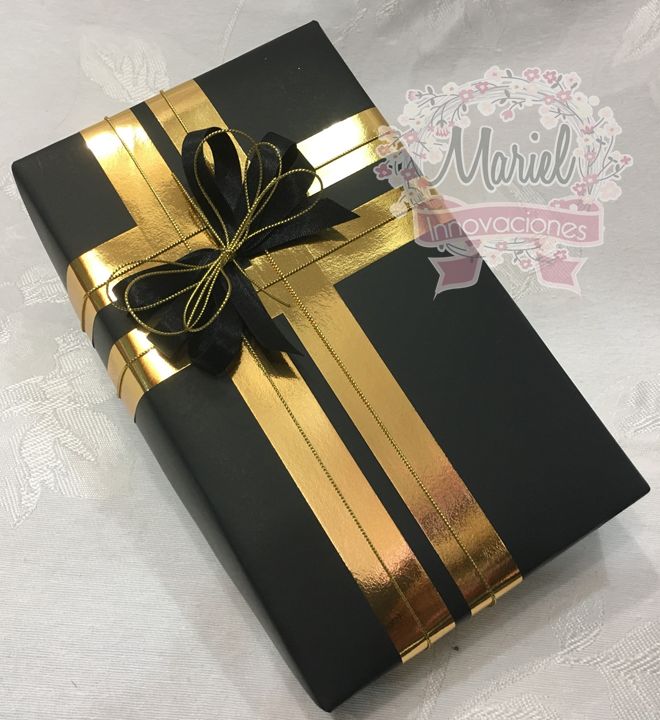 a black and gold wrapped gift box with ribbon