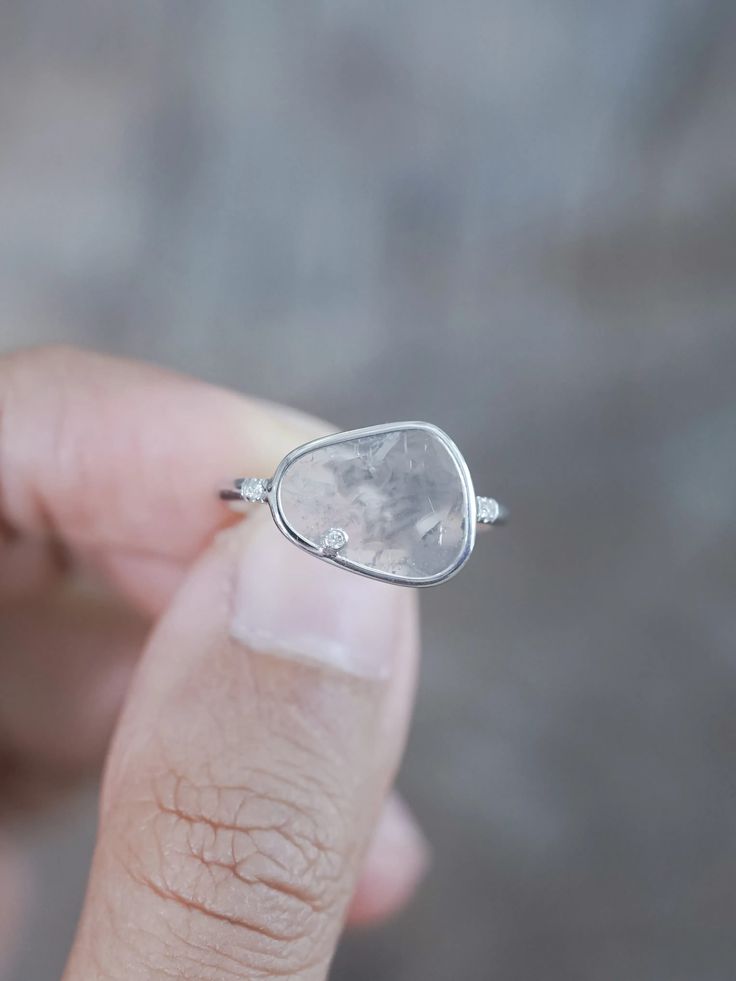 This diamond slice was mined in Botswana and then laser cut in India. It's translucent with inclusions in various shades of grey that give it so much character. It has both internal flaws as well as a surface pit. Wear this big diamond slice ring with the rose cut diamond necklace. Delicate Silver Rings With Single Cut Diamonds, Promise Jewelry With Single Cut Diamonds In Sterling Silver, Delicate Silver Diamond Ring With Single Cut Diamonds, Unique White Gold Jewelry With Si Clarity, Sterling Silver Rose Cut Diamond Jewelry For Promise, Delicate Sterling Silver Ring With Single Cut Diamonds, Delicate Silver Ring With Rose Cut Diamonds, Ethereal Diamond Gemstone Jewelry, White Gold Teardrop Diamond Ring With Gemstone