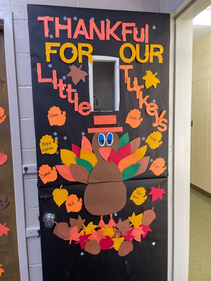 a door decorated to look like a turkey with the words thank you for our little turkey