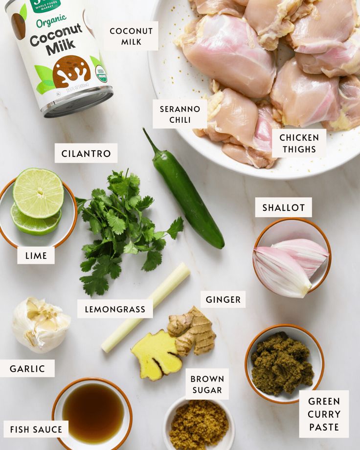 ingredients to make chicken broth laid out on a white counter top, including onions, cilantro, limes, garlic, and seasonings