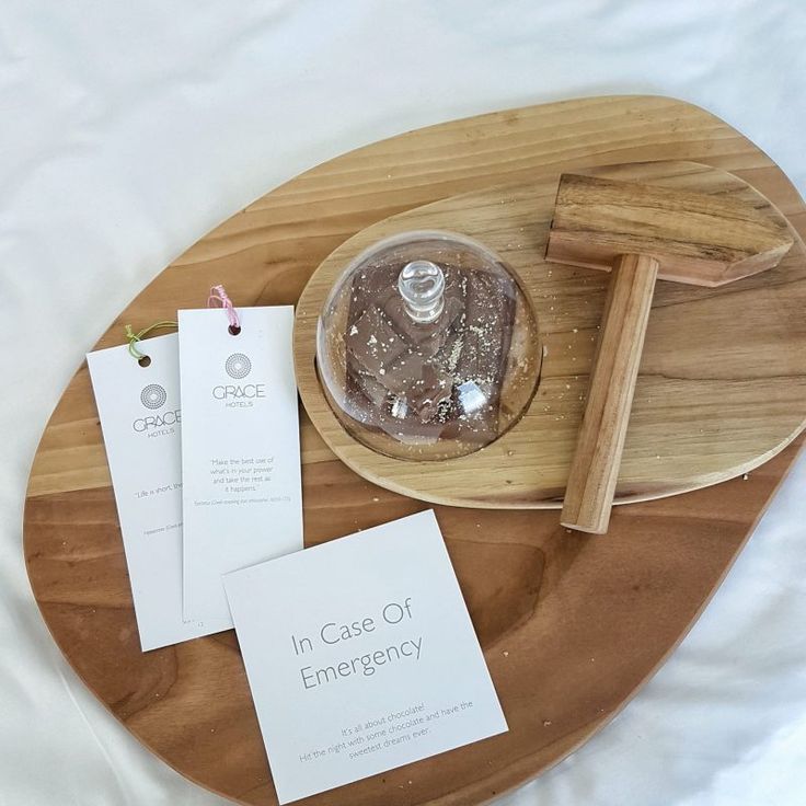 a wooden tray topped with a cake and two cards