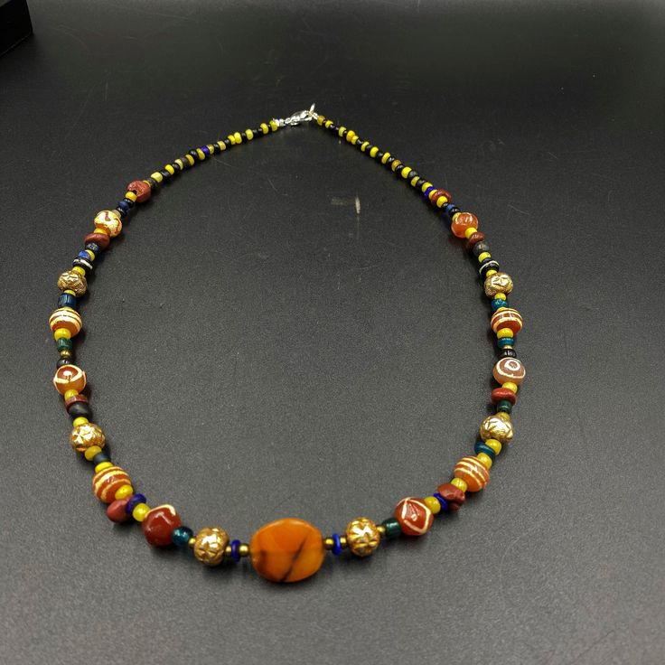 The Beautiful Necklace Consist Of Ancient Glass Beads ,Beautiful Luk Mik Or Magic Eye Agate and Etched Carnelian Agate From Indo Himalaya Some Gold Plated Wax Beads and Some Gold Color Brass Beads Are Used As Spacers Handmade Multicolor Carnelian Beads, Gems, And Cabochons, Multicolor Carnelian Jewelry With Large Beads, Multicolor Large Beads Agate Necklace, Handmade Multicolor Agate Beads, Multicolor Carnelian Necklaces With Polished Beads, Multicolor Agate Large Beaded Necklaces, Multicolor Agate Beaded Necklace With Large Beads, Multicolor Agate Beaded Necklaces With Oval Beads, Traditional Agate Necklaces With Colorful Beads