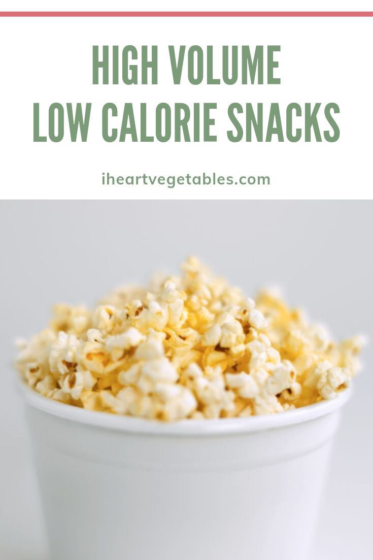 a white bowl filled with popcorn and the words high volume low calorie snacks