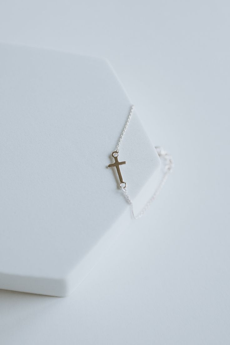 This precious cross bracelet is handcrafted with sterling silver and custom fit to your wrist, ensuring long-lasting style and quality. Invest in this timeless piece to cherish and wear for a lifetime.∙ D E T A I L S ∙- 6.5" plus Extension.- 925 Stamped Sterling Silver- 1mm Cable Chain- Cross Measure: 8mm ∙ STERLING ∙ SILVER ∙ Sterling silver is a metal alloy created by combining 92.5% pure silver with 7.5% other metals, typically copper. While Sterling Silver may darken due to oxygen exposure it can easily be polished without damaging the metal itself. You should even be able to pass your silver jewellery on to future generations! Dainty Adjustable Cross Jewelry, Dainty Sterling Silver Cross Bracelet, Minimalist Sterling Silver Cross Bracelet, Silver Cross Bracelets For Gifts, Silver Bracelet With Cross Pendant As Gift, Spiritual Silver Cross Bracelet, Silver Cross Bracelet, Spiritual Style, Nickel Free Silver Cross Bracelets, Nickel Free Sterling Silver Cross Bracelets