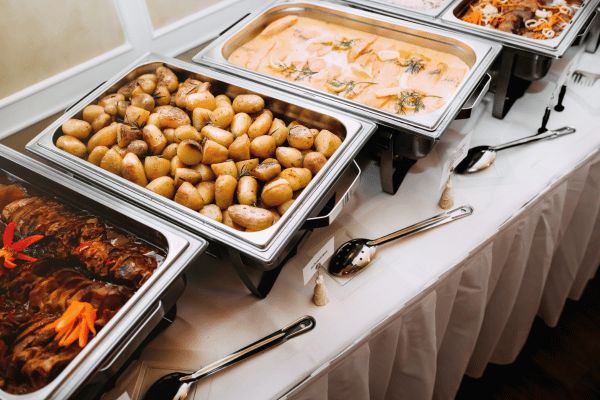 several trays of food sitting on top of a table