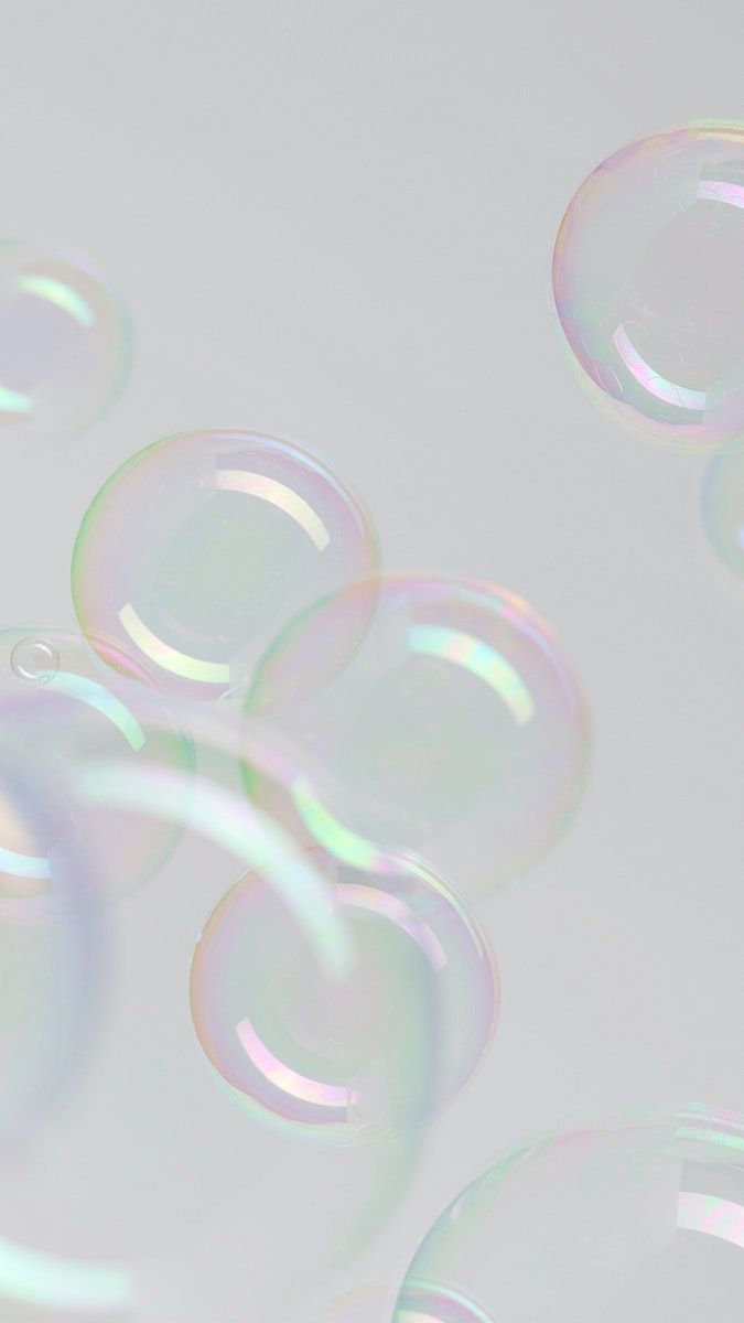 soap bubbles are floating in the air on a white surface with no one around them