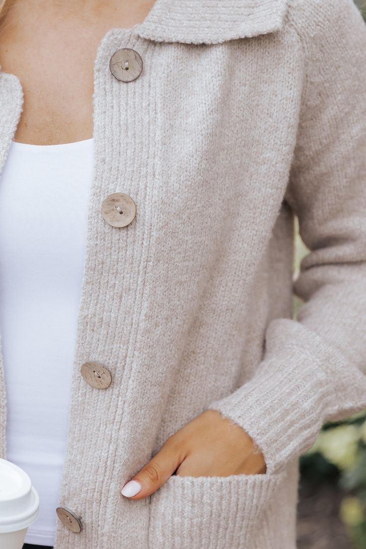 Stay cozy and chic with the Beige Button Down Sweater Cardigan, a versatile staple perfect for any season! Crafted with long sleeves and a collared neckline, this cardigan offers a classic touch to your layered looks. The button down front closure allows for easy styling, whether worn open over a tee or buttoned up for a polished finish. For a casual everyday outfit, simply pair it with leggings and your favorite sneakers. Everyday Soft Knit Button-up Outerwear, Button-up Knit Outerwear For Layering, Everyday Buttoned Sweater For Fall, Everyday Button Sweater For Fall, Everyday Fall Sweater With Buttons, Everyday Button-up Sweater For Fall, Everyday Button-up Sweater With Button Closure, Soft Texture Cardigan For Everyday Fall Wear, Soft Texture Everyday Winter Cardigan