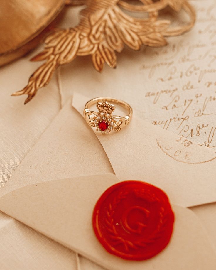 The Gold Claddagh Ring was a design from love. Especially for the Paris lovers! We have designed a cute ring inscription inside that says I ❤️ Paris. This Beautiful ring is 18kt gold plated silver with red cubic zirconia and faux pearls. Vintage Promise Jewelry For Valentine's Day, Heirloom Style Valentine's Day Jewelry Ring, Valentine's Day Heirloom Ring Jewelry, Valentine's Day Heirloom Ring, Heirloom Heart Ring With Birthstone For Valentine's Day, Valentine's Day Heirloom Heart Ring With Birthstone, Heirloom Promise Ring Jewelry For Valentine's Day, Heirloom Ruby Ring Gift For Valentine's Day, Heirloom Heart-shaped Rings For Gifts