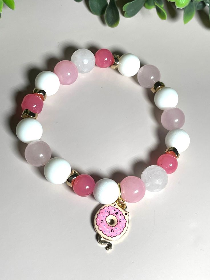 Donut kitty beaded bracelet all glass beads. 7" inch can be resized up to 8" upon request. Gold tone accents Cute Round Beaded Bracelets For Birthday, Pink Novelty Stretch Bracelet For Birthday, Novelty Pink Stretch Bracelet For Birthday, Playful Round Beaded Jewelry, Sweet Pink Jewelry With Heart Beads, Sweet Pink Hypoallergenic Jewelry, Sweet Pink Jewelry With Colorful Beads, Pink Novelty Jewelry With Colorful Beads, Pink Beaded Novelty Jewelry