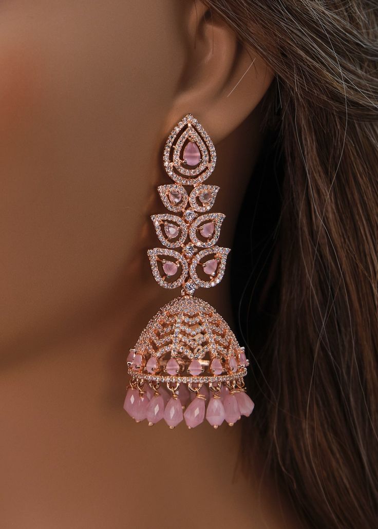 A premium quality statement CZ long jhumki earrings with Monalisa Stone and Beads tassels. Add a pop of color with this trendy long Jhumki for a touch of sparkle in your festive looks. Length: Approx. 3" Weight of each earring: 21 gms Push-Back closure Finish: Rose Gold Polish High-quality brass as the base metal. Availability: In-Stock. *Color may vary slightly due to light condition & photography. Jewelry Care: Keep away from moisture. Allow perfumes and lotion to dry before wearing. Store in Festive Nails Indian, Dreamy Earrings, Stylish Jewelry Accessories, Gold Jhumkas, American Diamond Earrings, Beads Tassels, Long Statement Earrings, Photography Jewelry, Indian Wedding Jewelry Sets