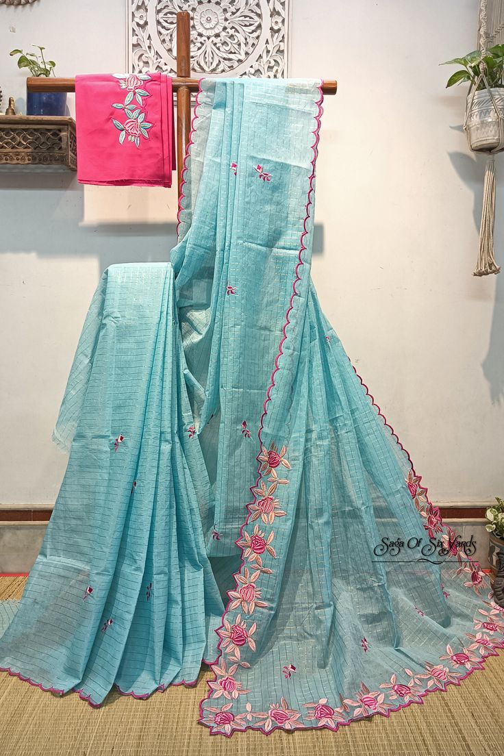 Introducing our exquisite, embroidered handloom zari check pure cotton by cotton saree - a perfect blend of elegance and tradition. This beautiful saree features floral embroidery with a scalloped border.The zari checks woven into the fabric add a touch of shimmer to this saree.Comfort is key, and this saree doesn't disappoint. Crafted from pure handloom cotton, it's not only lightweight and summer-friendly but also incredibly comfortable to wear all day long. Complete your look with the included embroidered contrast blouse piece, and you're ready to make a statement on any special occasion. Experience the perfect blend of tradition, style, and comfort with our Handloom zari check pure cotton by cotton saree. Details: Saree length: 6.25 mtrs [Approx] Saree width: 44 inches Blouse: With Emb Cotton Dupatta With Zari Work, Cotton Dupatta With Resham Embroidery For Festivals, Blue Cotton Dupatta With Zari Weaving, Blue Cotton Dupatta With Cutdana, Festive Cotton Saree With Chikankari Embroidery, Unstitched Cotton Handloom Traditional Wear, Blue Cotton Saree With Zari Weaving, Unstitched Cotton Saree With Chikankari Embroidery, Cotton Chikankari Embroidered Saree