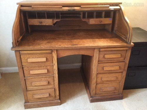 an old wooden desk with drawers on it